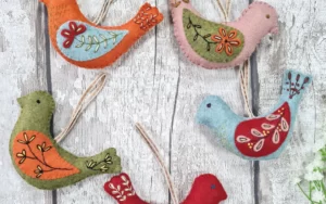 Five felt birds with hand embroidery.