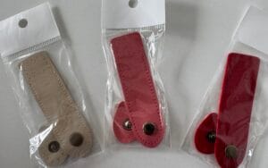 Bag fastenings with metal poppers.