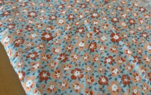 Floral Viscose - Pale blue and orange print. 1.5m length.