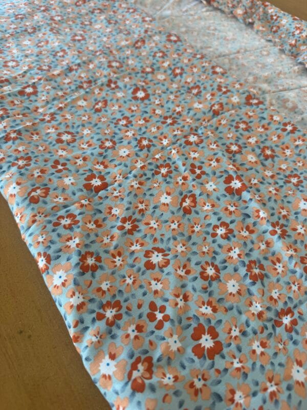 Floral Viscose - Pale blue and orange print. 1.5m length.